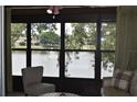 Screened in patio showing serene lake view with fountain and comfortable seating at 3861 Sailmaker Ln # 3861, Holiday, FL 34691
