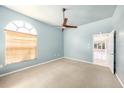 Cozy bedroom with large window, ceiling fan, and carpet flooring at 4270 Boston Cir, New Port Richey, FL 34653