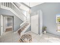 Bright foyer featuring tile flooring, staircase, and stylish accents at 4270 Boston Cir, New Port Richey, FL 34653