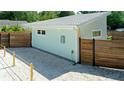 Side exterior featuring modern design elements, a well-maintained yard, and a privacy fence at 5111 28Th N Ave, St Petersburg, FL 33710
