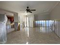 View of the living room showing tile flooring, front door, and open access to the kitchen at 5813 Oxford Dr, Tampa, FL 33615