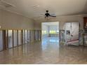 Bright living room featuring tile floors and views into the bright sunroom and open kitchen area at 5813 Oxford Dr, Tampa, FL 33615