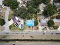 Overhead shot of the home, set within a leafy neighborhood with a view of nearby properties and the surrounding area at 6715 16Th N St, St Petersburg, FL 33702
