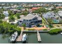 Beautiful waterfront home with a screened lanai, boat dock, and a private pool at 915 Symphony Isles Blvd, Apollo Beach, FL 33572