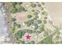 An aerial view of the property location, featuring a home near a lake with mature trees at 9722 Kenton Rd, Wesley Chapel, FL 33545