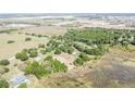 A beautiful aerial view of the surrounding area, with a pond and a cluster of houses at 9722 Kenton Rd, Wesley Chapel, FL 33545