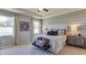 Spacious main bedroom featuring tray ceilings, carpet floors, and a large window for ample natural light at 10421 Gentle Rain Dr, Land O Lakes, FL 34638