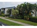 Well-maintained exterior with mature landscaping and lush hedges bordering the sidewalk at 11201 122Nd Ave # 126, Largo, FL 33778