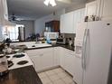 Efficient kitchen featuring white cabinets, black countertops and appliances at 11201 122Nd Ave # 126, Largo, FL 33778