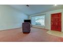 Bright living room with window view, comfortable seating, and classic interior door at 11325 Glenmont Dr, Tampa, FL 33635