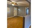 Inviting living room featuring wood flooring, and great natural light from a window near the door at 12230 Skyler Ln, Spring Hill, FL 34609