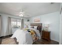 Bright bedroom featuring a ceiling fan, a decorative window, and a wood floor at 12913 126Th Ter, Largo, FL 33774