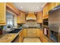 Well-equipped kitchen with stainless steel appliances and lots of wood cabinets at 12913 126Th Ter, Largo, FL 33774
