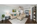 Cozy living room with comfortable sofas, a ceiling fan, and a decorative rug at 12913 126Th Ter, Largo, FL 33774
