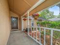 Inviting front porch with hanging flower baskets and decorative landscaping creating a welcoming entrance at 16015 Glen Haven Dr, Tampa, FL 33618