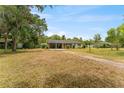 Large yard with a home that includes a carport, perfect for outdoor activities and relaxation at 1609 S Valrico Rd, Valrico, FL 33594