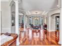 Elegant dining room with wood floors, tray ceiling, chandelier, and large windows overlooking the grounds at 16124 Suncrest Shores Dr, Odessa, FL 33556