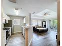 Open living area featuring modern gray floors, neutral walls, and light-filled balcony access at 18001 Richmond Place Dr # 330, Tampa, FL 33647