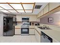 Functional kitchen with stainless steel appliances, white countertops, and ample cabinet space at 18400 Gulf Blvd # 1105, Indian Shores, FL 33785