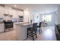 Modern kitchen with granite countertops, stainless steel appliances, and white cabinetry at 18933 Sailors Delight Pass, Land O Lakes, FL 34638