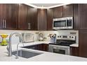 Modern kitchen featuring stainless steel appliances and sleek countertops at 2626 2Nd Ct, Palm Harbor, FL 34684