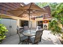 Private outdoor patio with seating area, umbrella, and storage at 2626 2Nd Ct, Palm Harbor, FL 34684