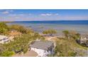 An aerial view showcasing the coastal location of the property, with a pier and ocean views at 2802 Northpointe Ln, Tampa, FL 33611