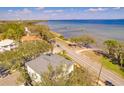An aerial view of the home displaying a coastline with pier, and neighborhood at 2802 Northpointe Ln, Tampa, FL 33611