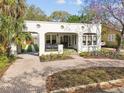 Charming white stucco home with a brick driveway and front yard at 2911 W Estrella St, Tampa, FL 33629
