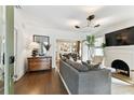 Inviting living room with hardwood floors, fireplace, and modern chandelier at 2911 W Estrella St, Tampa, FL 33629