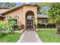 Close up of the entry to a home with beautiful landscaping and brick walkway at 3013 Crest Dr, Clearwater, FL 33759