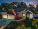 Beautiful home with well-manicured front yard and three-car garage, situated on a landscaped lot at 3047 Lake Padgett Dr, Land O Lakes, FL 34639