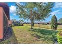 Expansive backyard featuring well-maintained landscaping and pond views at 310 Cedar Falls Dr, Apollo Beach, FL 33572