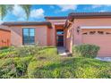 Welcoming front entrance with a garden and well-maintained landscaping at 310 Cedar Falls Dr, Apollo Beach, FL 33572