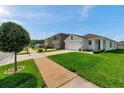 Beautiful home in a peaceful neighborhood, showcasing a well-manicured lawn and charming curb appeal at 32714 Brooks Hawk Ln, Wesley Chapel, FL 33543