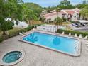 An aerial shot of a community pool with lounge chairs and pristine landscaping at 3505 Tarpon Woods Blvd # K409, Palm Harbor, FL 34685