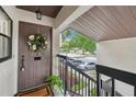 Inviting front door with wreath, leading to a well-maintained porch with views of the community at 3505 Tarpon Woods Blvd # K409, Palm Harbor, FL 34685
