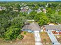 An aerial view shows a home nestled within a lush, tree-filled neighborhood at 4435 Lamson Ave, Spring Hill, FL 34608