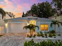 Charming single-Gathering home boasts a paved driveway, a two-car garage, and vibrant landscaping at 475 Crystal Beach, Crystal Beach, FL 34681