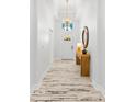 Bright hallway with decorative floors and a modern chandelier at 475 Crystal Beach, Crystal Beach, FL 34681