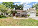 Charming home with a manicured lawn, a two-car garage, and beautiful landscaping, creating excellent curb appeal at 4915 Fort Peck Rd, New Port Richey, FL 34655