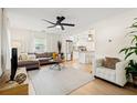 Bright living room featuring modern ceiling fan, neutral furniture, and stylish decor at 5724 Dr Martin Luther King Jr N St, St Petersburg, FL 33703