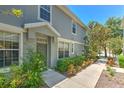 Charming home exterior with a covered entry, well-manicured shrubs, and a sidewalk leading to the front door at 6782 Breezy Palm Dr, Riverview, FL 33578