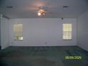 Spacious living room featuring plush carpeting, neutral walls, and lots of natural light at 7224 Ryman Loop, Zephyrhills, FL 33540