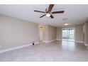 Bright living room featuring tile floors and sliding door to patio at 7405 Oakshire Dr, Port Richey, FL 34668