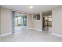 Bright living space with access to a screened patio and modern kitchen at 7405 Oakshire Dr, Port Richey, FL 34668