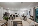 Open-concept living room with light wood flooring, neutral walls, and stylish furnishings at 10009 Surrey Rose Dr, San Antonio, FL 33576