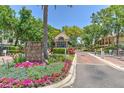 Beautiful entrance to Island Place Island Walk, featuring manicured landscaping and a charming guard house at 1111 Normandy Trace Rd # 1111, Tampa, FL 33602