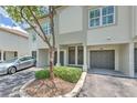 Townhome featuring private entrances, covered parking, and well-maintained landscaping offering curb appeal at 1111 Normandy Trace Rd # 1111, Tampa, FL 33602
