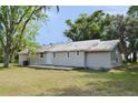 Single-story home featuring a metal roof and back porch at 11141 Rex Hunter Ln, Lithia, FL 33547